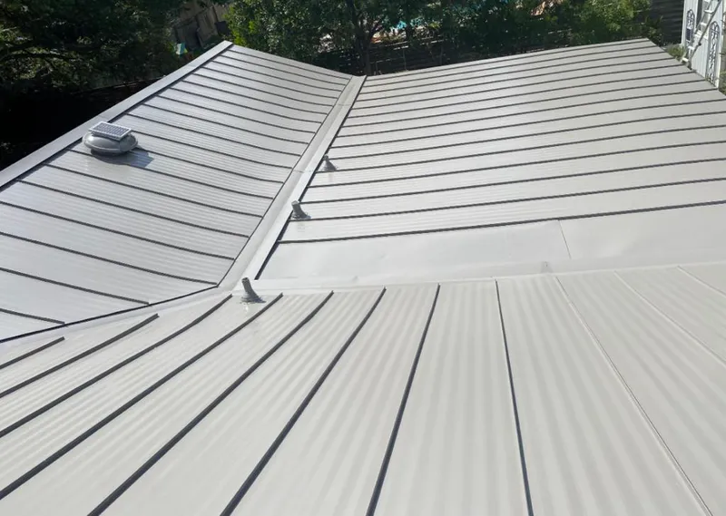 Solar attic fan installed on a metal roof for Roof Ventilation in Alpine
